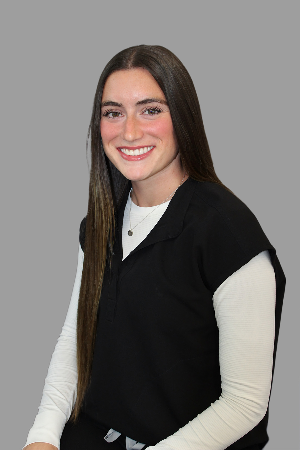The alt text should be descriptive and informative. Here s an example A young woman with long hair, wearing a black vest over a white shirt, posing for a portrait against a neutral background.